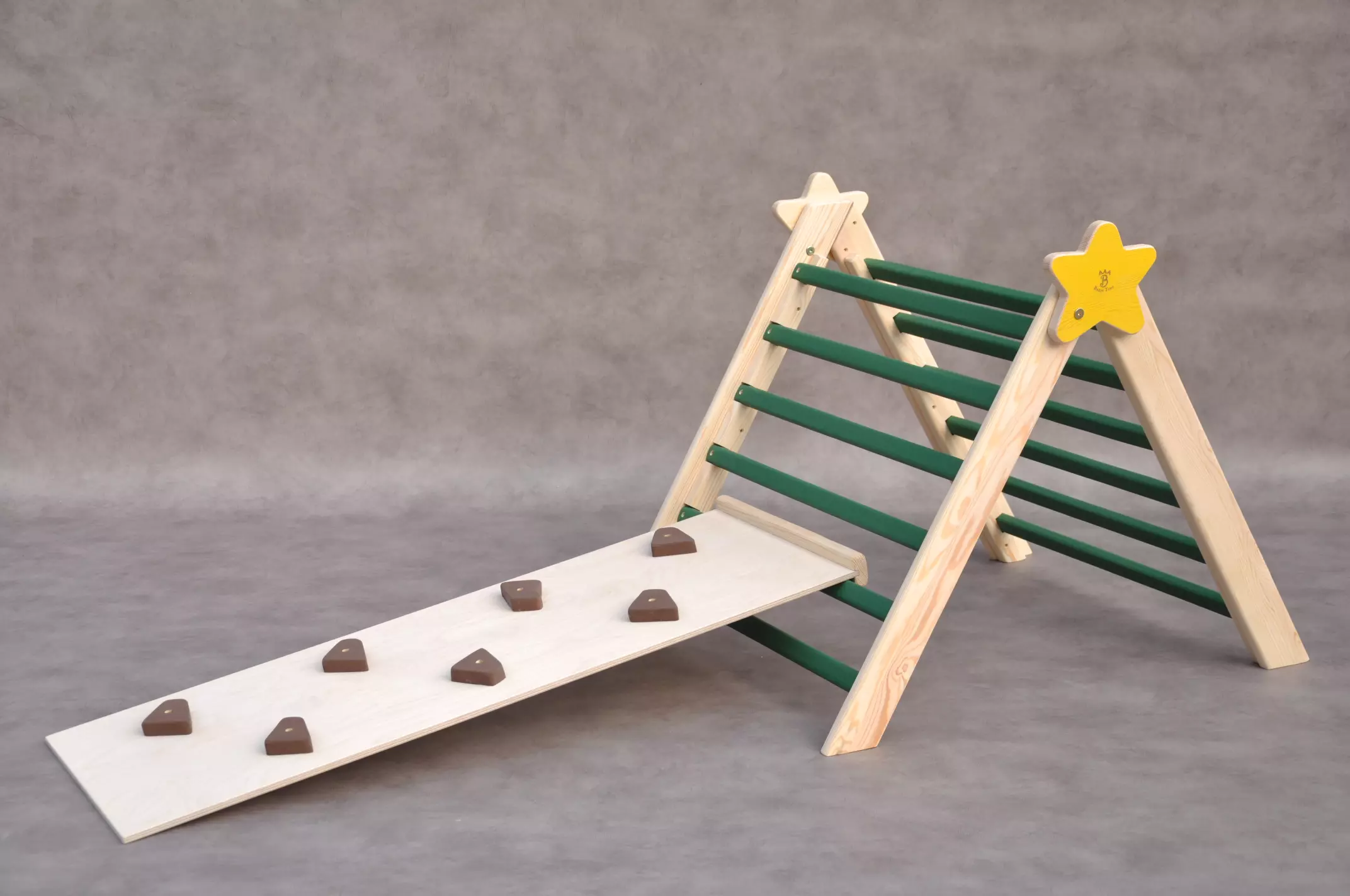 Indoor climbing frame Barin Toys Christmas Tree with a Star pikler triangle - foldable wooden frame in pine green color and pinecones slide board for toddler climbing activities and sliding games indoors.